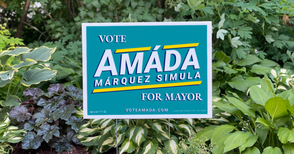 Teal campaign lawn sign that reads "Vote Amáda Márquez Simula for Mayor"