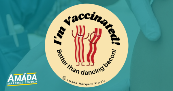 Cream colored button pin with two strips of bacon dancing that reads I'm vaccinated! Better than dancing bacon!