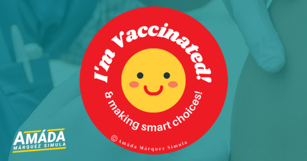 Red button pin with a smiley face that reads I'm vaccinated and making smart choices!