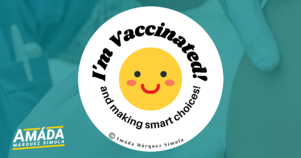 White button pin with a smiley face that reads I'm vaccinated and making smart choices!