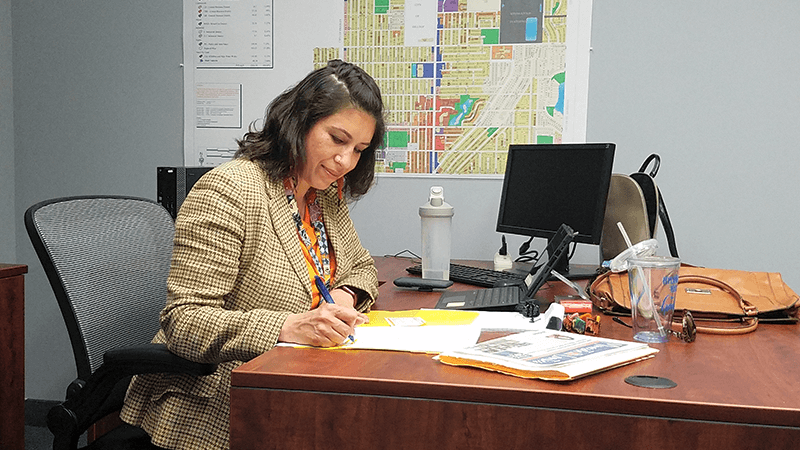 Mayor Amáda Márquez Simula signs documents in her office